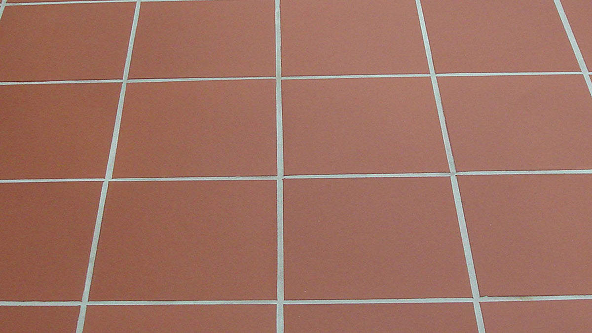 Unglazed red quarry tile floor with light grout lines