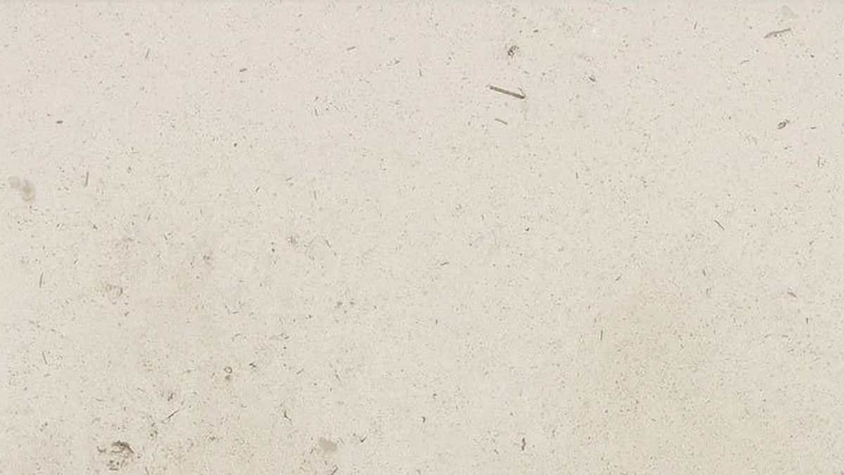Close-up of honed cream limestone surface