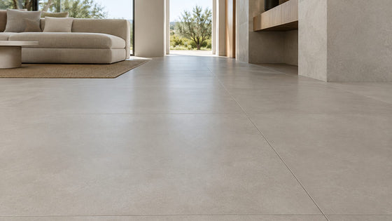 Large-format matt grey porcelain tile floor in a modern living area